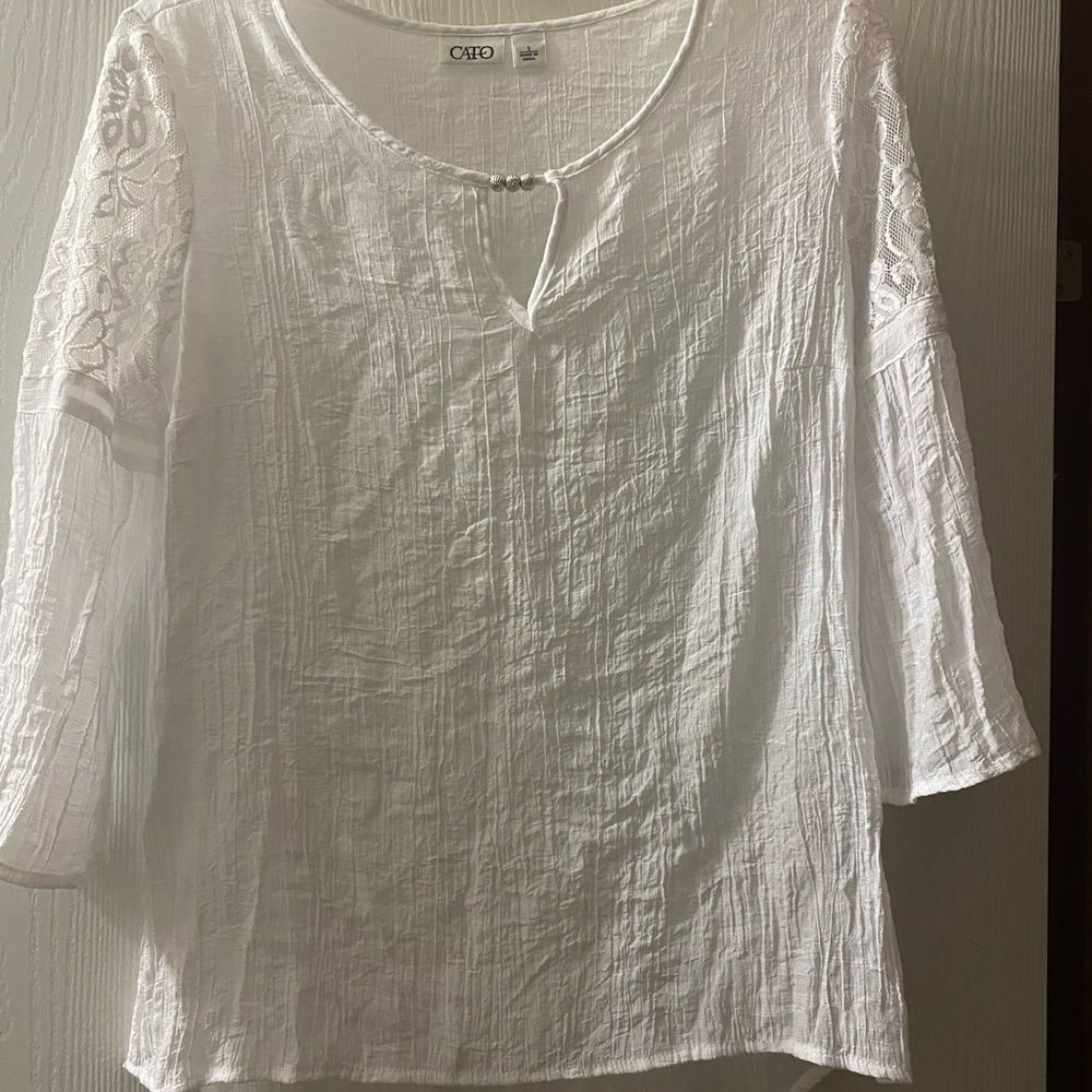 White lace top 3/4 bell sleeve and silver accents at the neck line.
